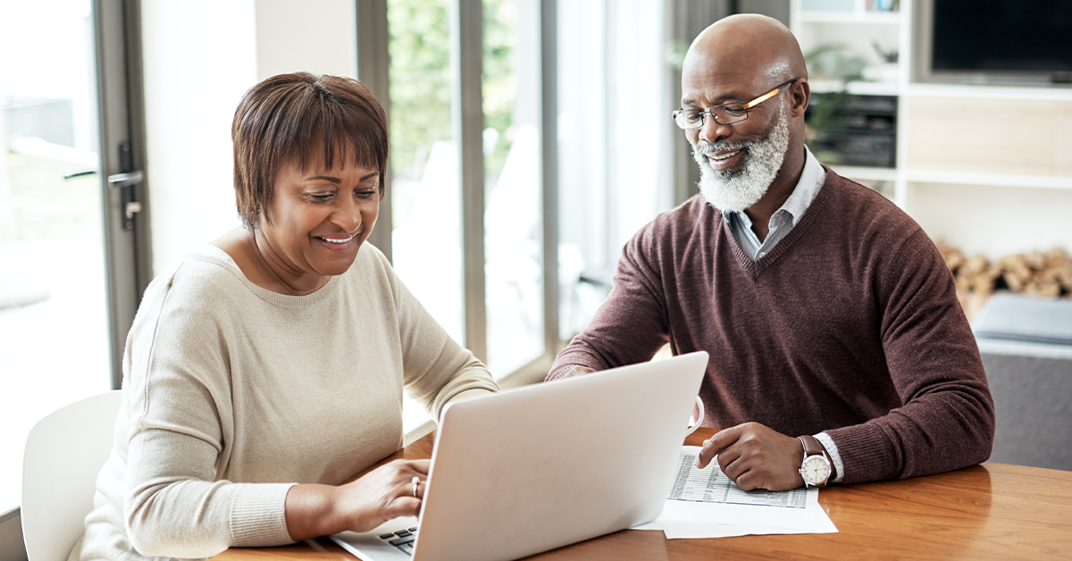 Couple looking at a laptop together